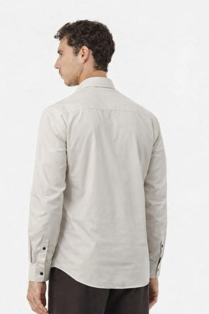 Man wearing a light gray shirt on a white background