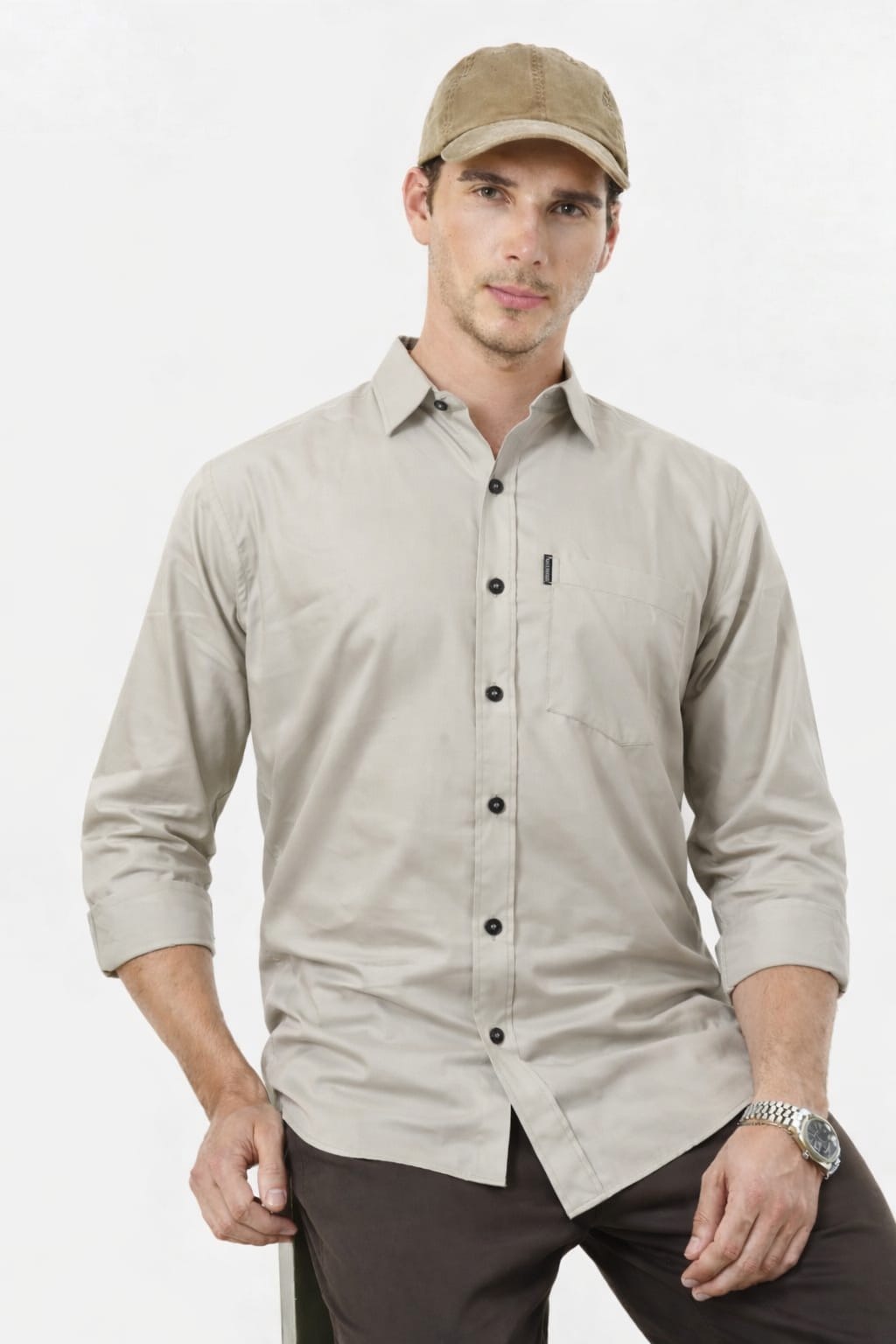 Man wearing a beige button-up shirt and cap on a white background