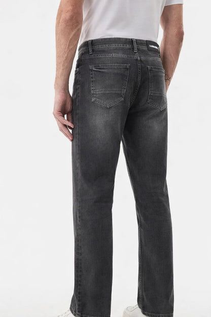 Person wearing black jeans on a white background
