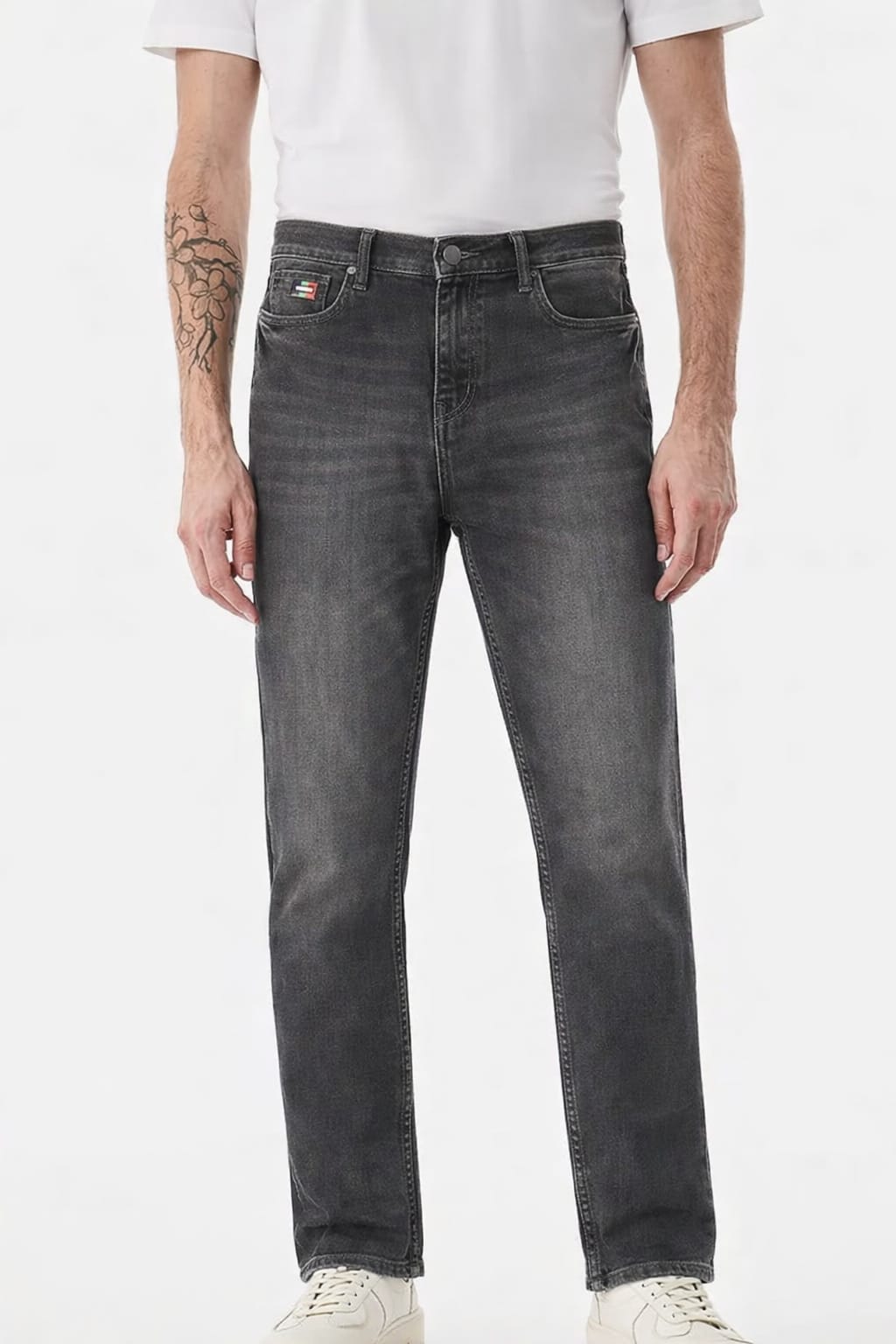 Person wearing gray jeans on a white background