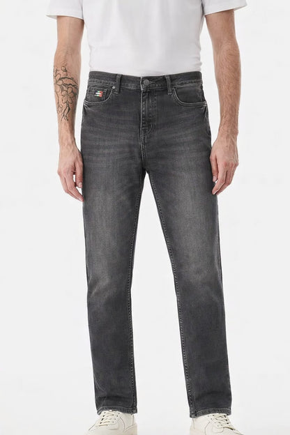 Person wearing gray jeans on a white background