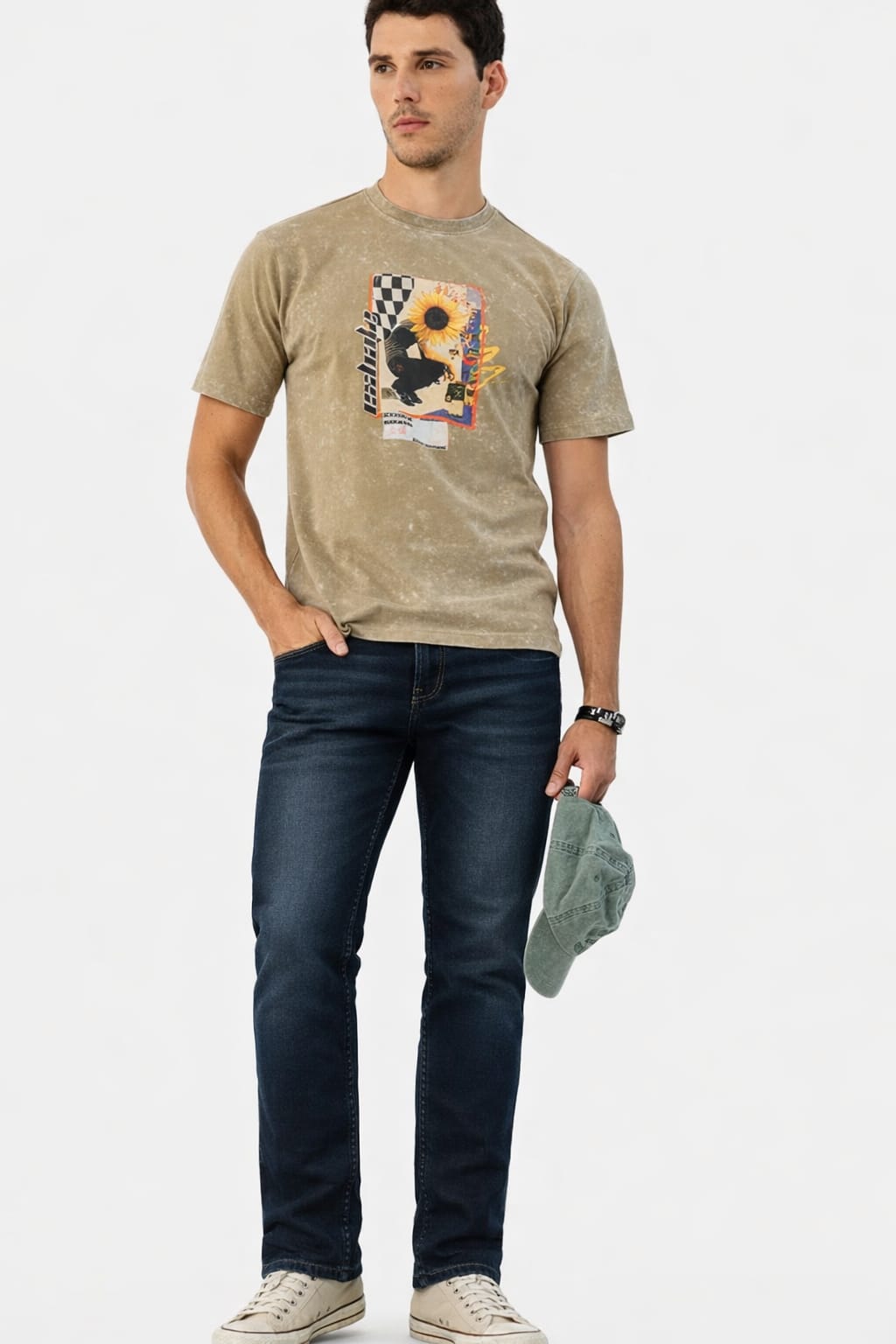Man wearing a beige t-shirt with a graphic design and dark jeans on a white background