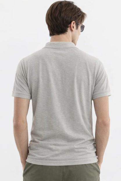 Man wearing a gray polo shirt from behind on a white background