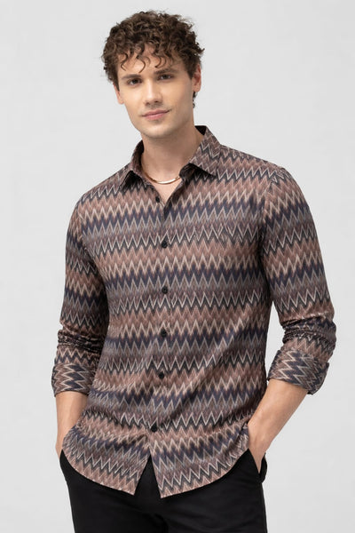 Man wearing a patterned shirt on a plain background