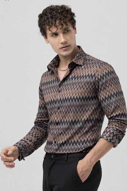 Man wearing a patterned shirt on a plain background