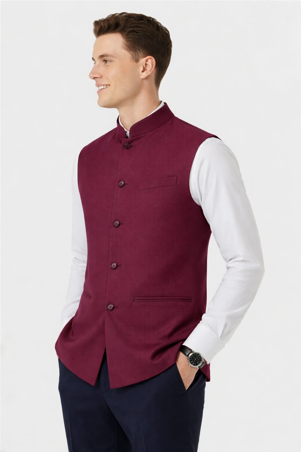 Man wearing a maroon vest over a white shirt on a white background