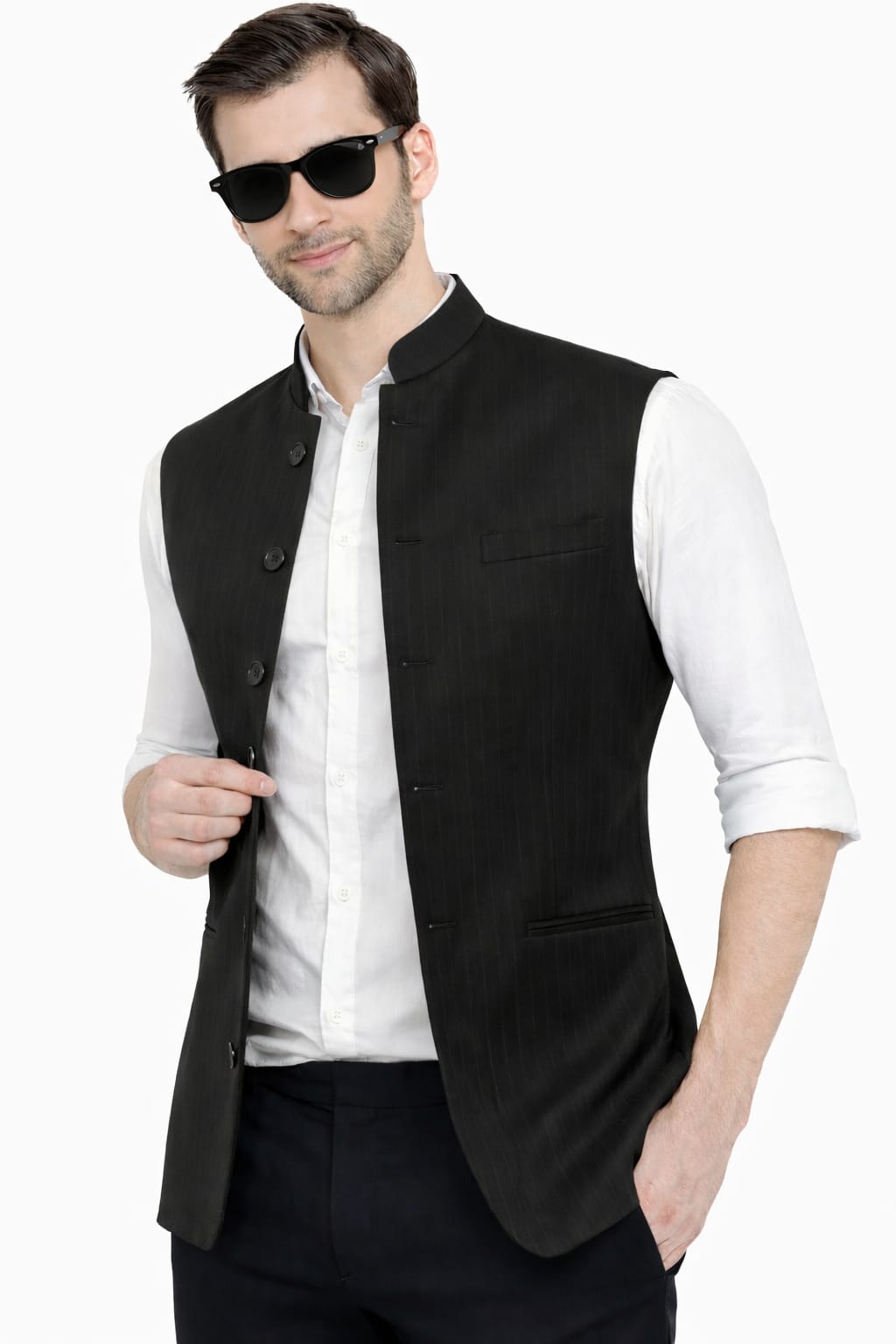 Man wearing a black vest over a white shirt with sunglasses on a white background