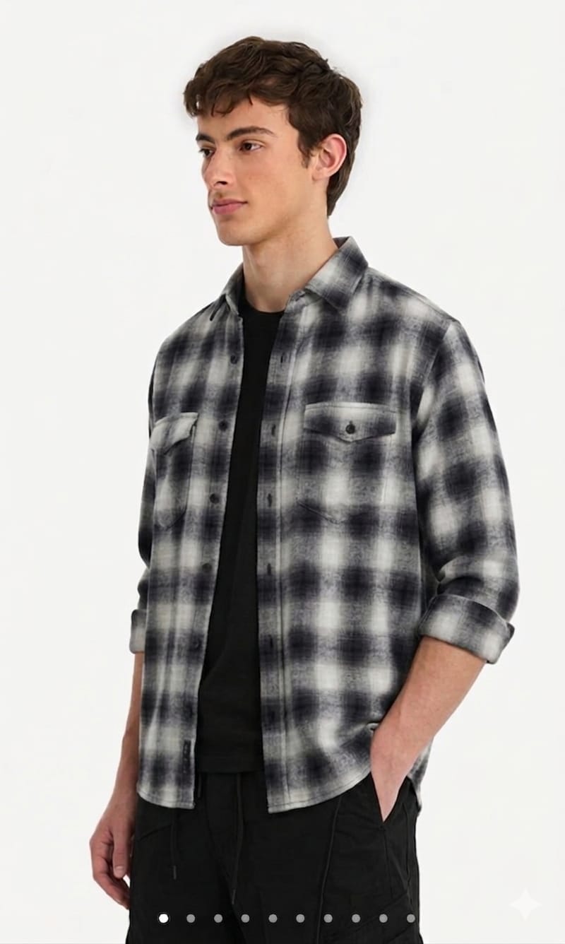 Man wearing a black and white plaid shirt on a white background
