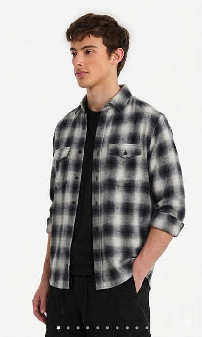 Man wearing a black and white plaid shirt on a white background