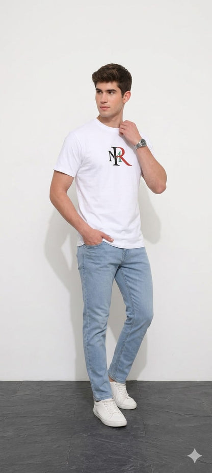 Man wearing a white t-shirt with a logo and light blue jeans against a white background