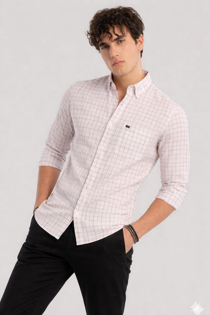Man wearing a pink checkered shirt and black pants on a gray background