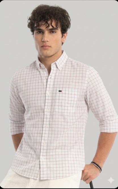 Man wearing a white checkered shirt with a gray background