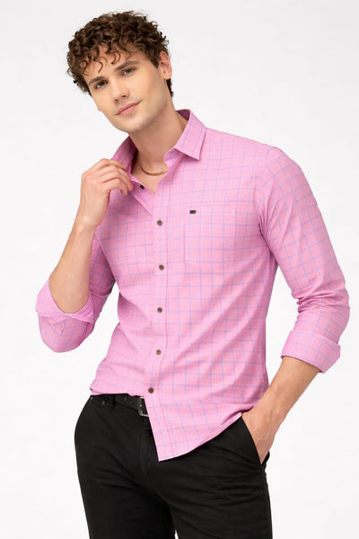 Man wearing a pink checkered shirt with rolled-up sleeves on a white background