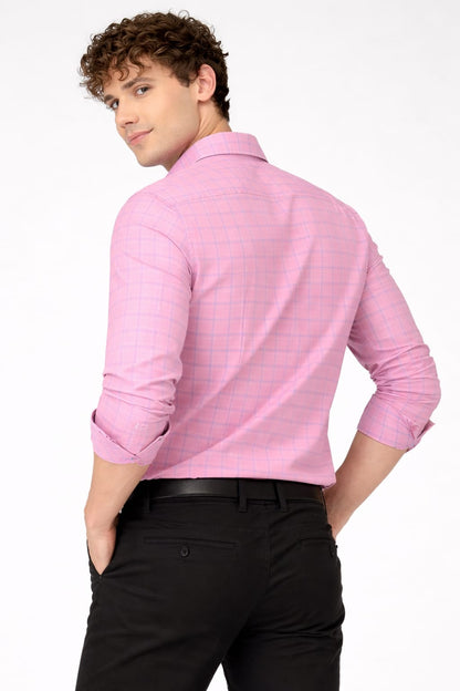 Man wearing a pink checkered shirt and black pants on a white background