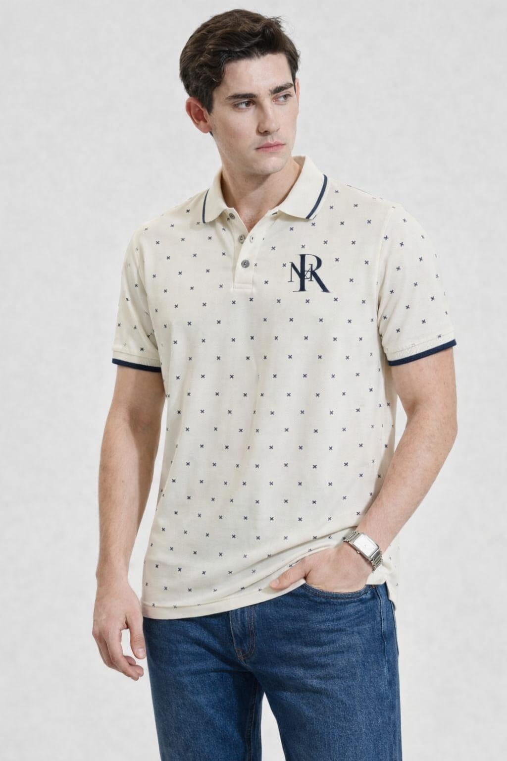 Man wearing a patterned polo shirt with a logo on a white background