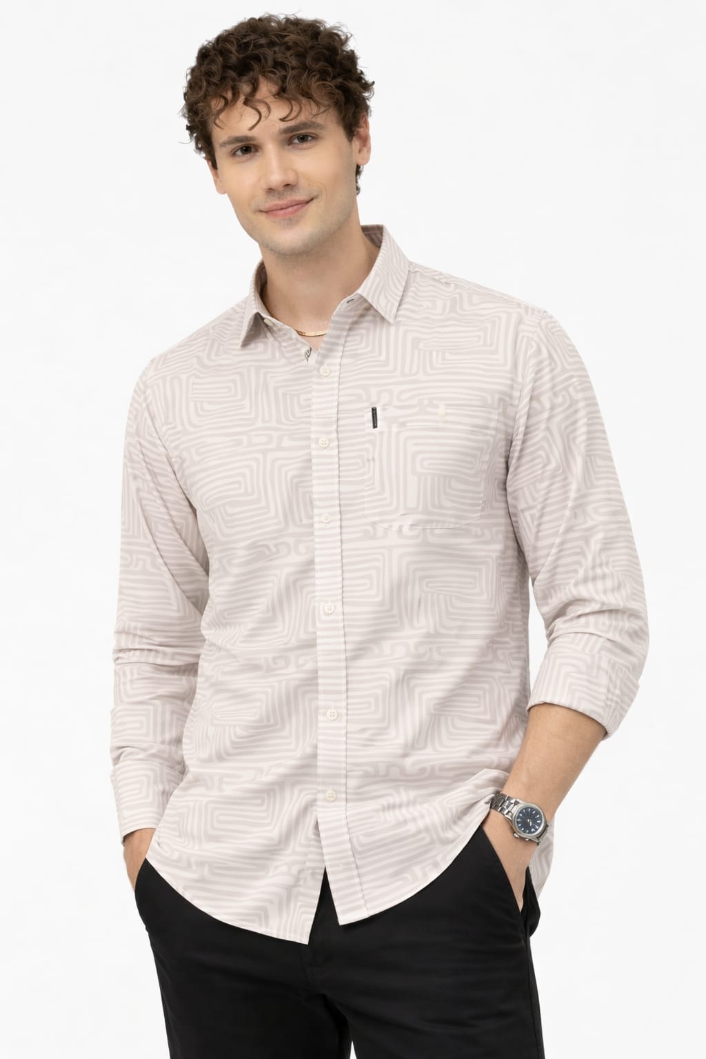 Man wearing a light patterned shirt and dark pants on a white background