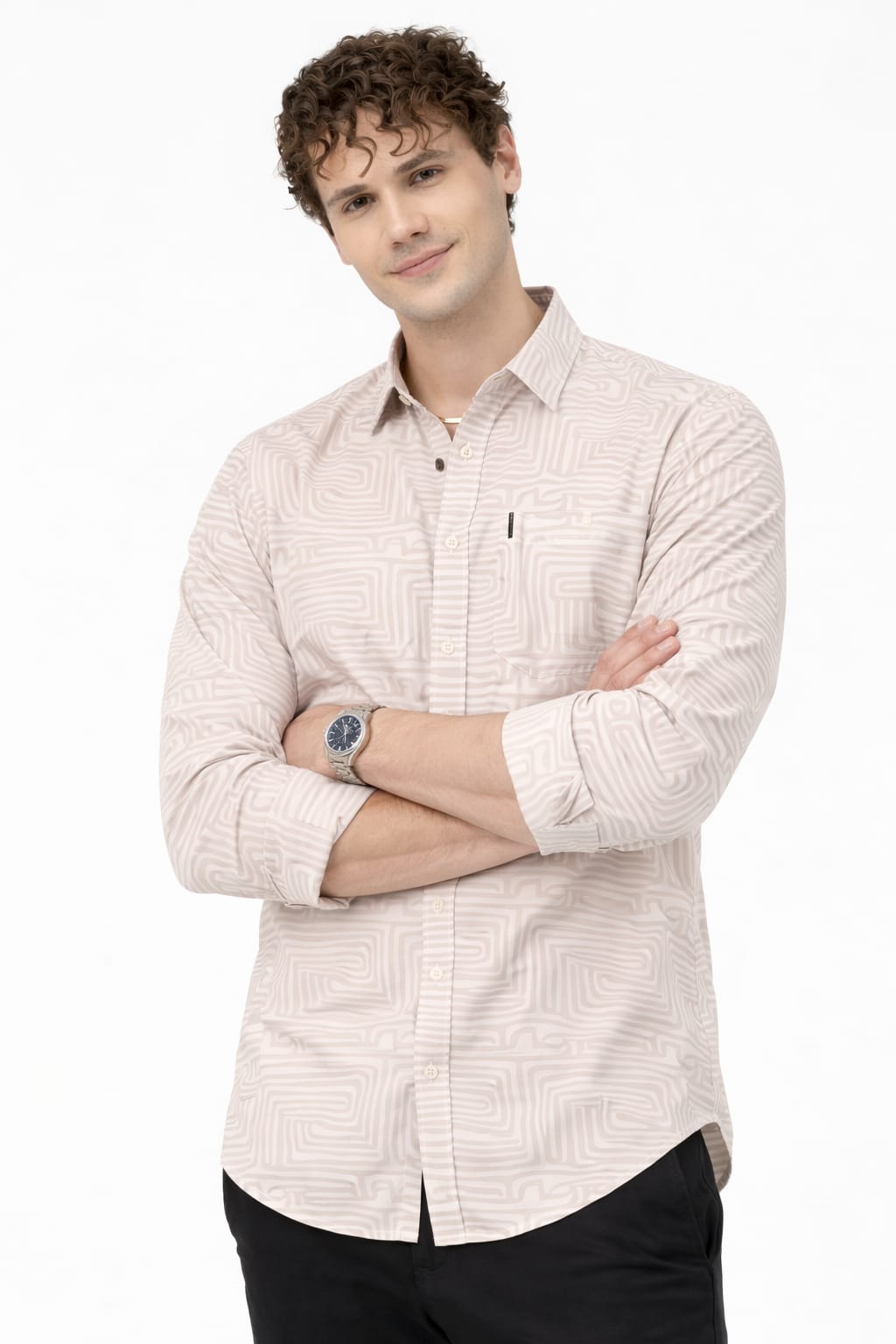 Man wearing a light-colored checkered shirt with arms crossed on a white background