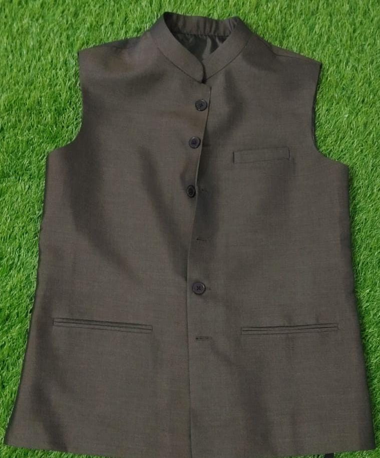 Brown vest with buttons on a green grass background
