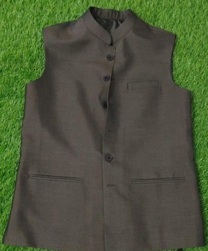 Brown vest with buttons on a green grass background