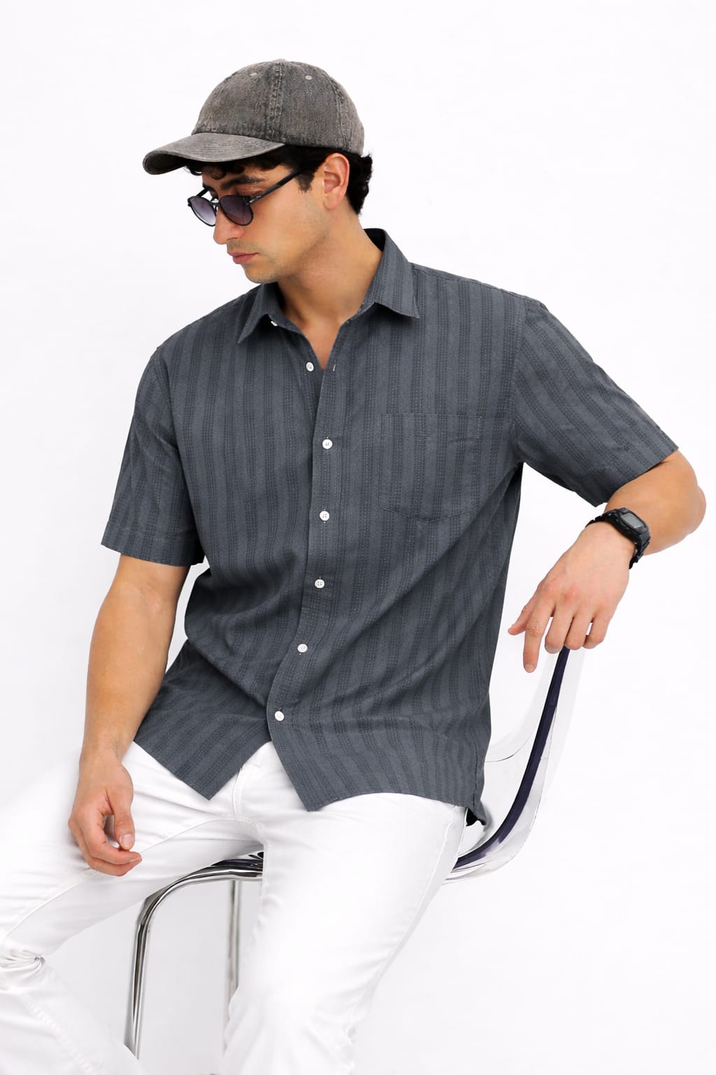 Man wearing a gray striped shirt and cap on a white background