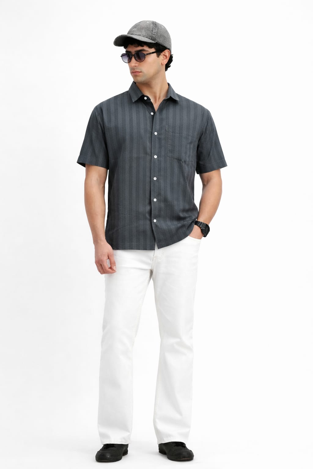 Man wearing a dark gray striped shirt, white pants, and a cap on a white background
